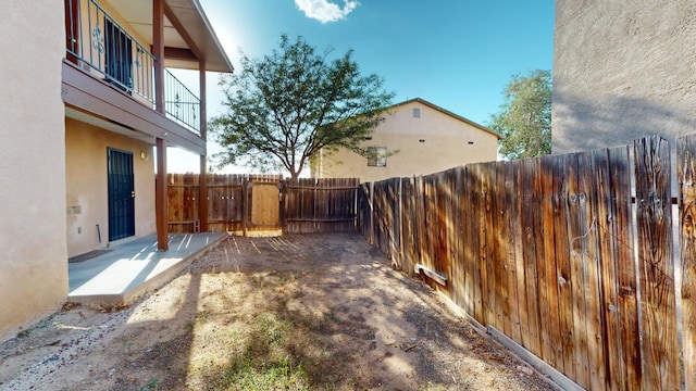 view of yard featuring a balcony and a patio area