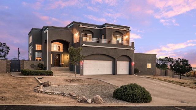 view of front of house featuring a balcony and a garage