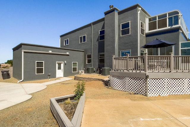 back of house with a deck, central AC unit, and a patio area