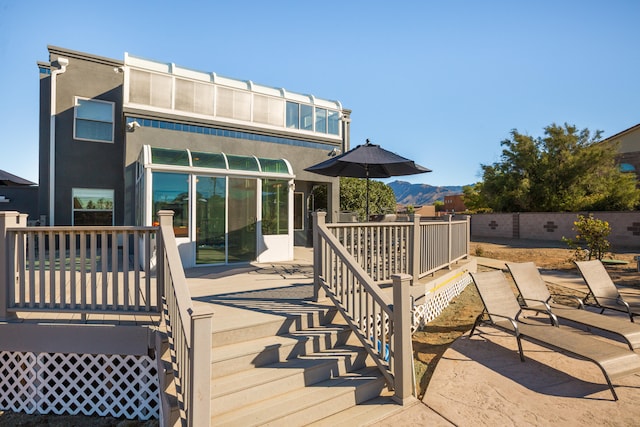 back of house with a wooden deck