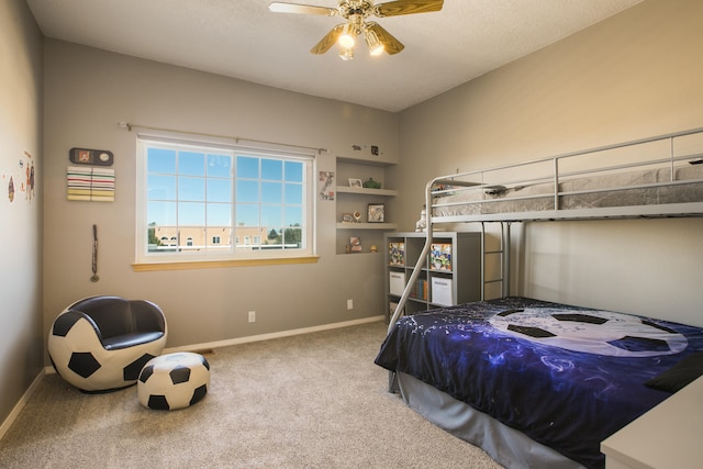 bedroom featuring ceiling fan and carpet