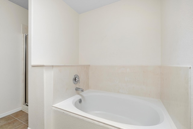 bathroom featuring tile patterned floors and separate shower and tub