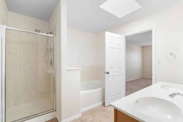 bathroom with vanity, shower with separate bathtub, and tile patterned floors