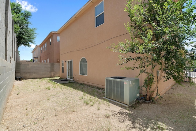 back of property featuring central AC