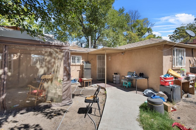 rear view of property featuring a patio area