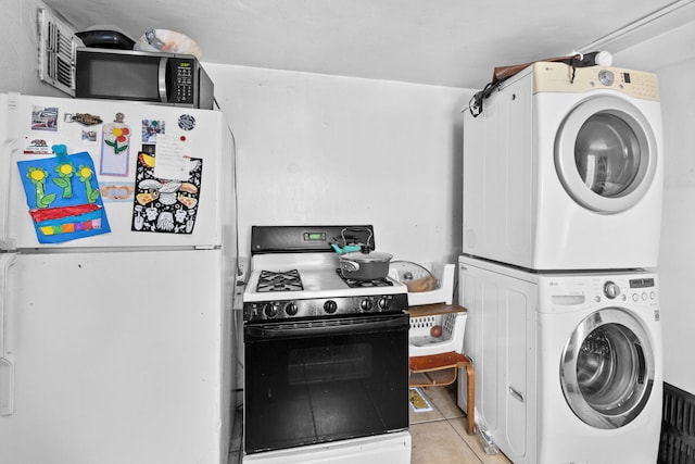 laundry room featuring stacked washer / dryer and light tile patterned floors