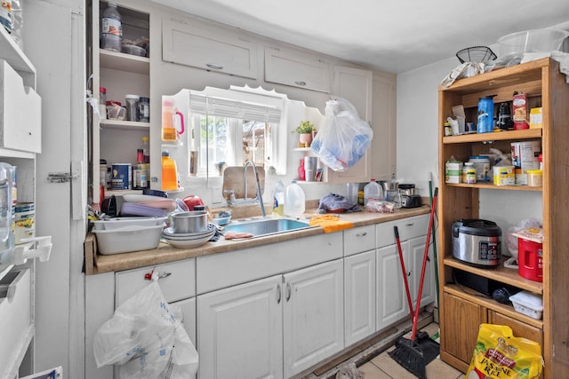 kitchen with white cabinetry and sink