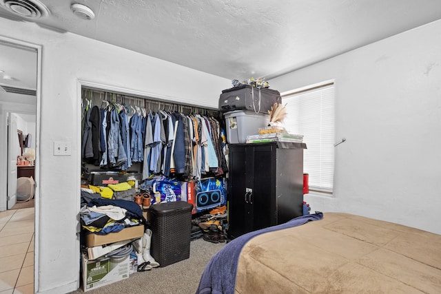 bedroom featuring light tile patterned flooring and a closet