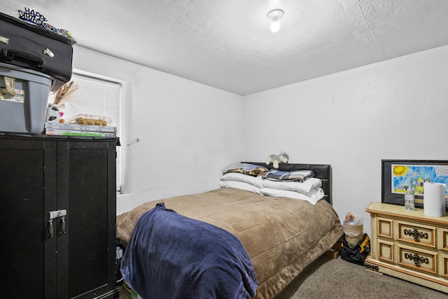 bedroom with carpet and a textured ceiling