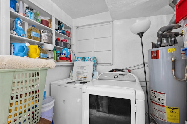 laundry room with water heater, washer and dryer, and a textured ceiling