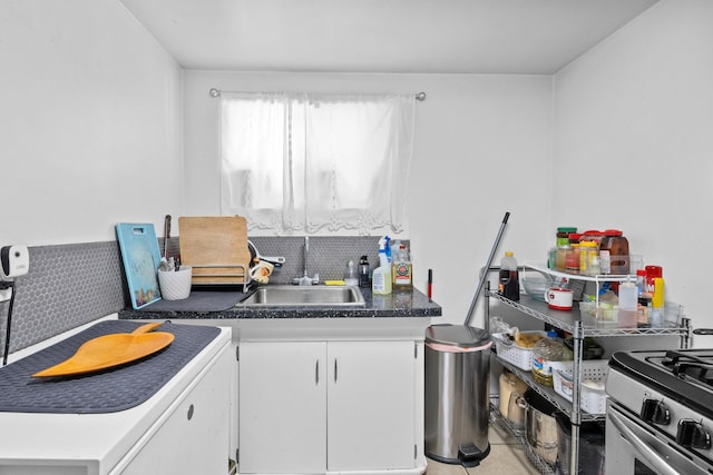 kitchen featuring sink and white cabinets