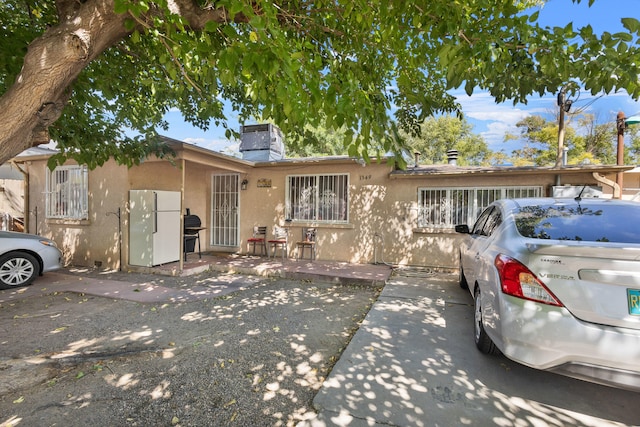 single story home featuring central air condition unit