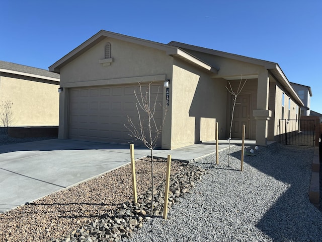 view of property exterior with stucco siding, a garage, and concrete driveway