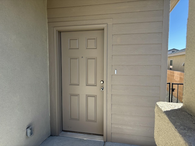 doorway to property with stucco siding