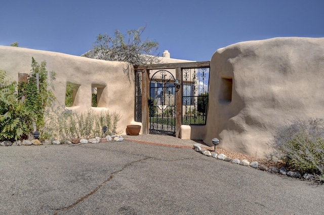 entrance to property with a gate and a chimney