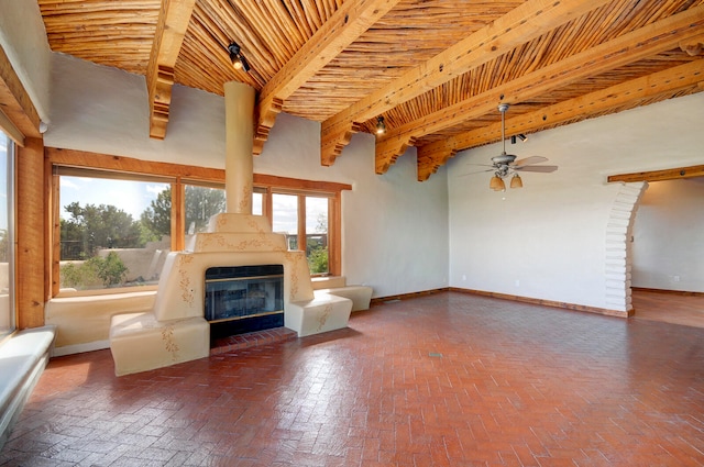 unfurnished living room with ceiling fan, beamed ceiling, and high vaulted ceiling