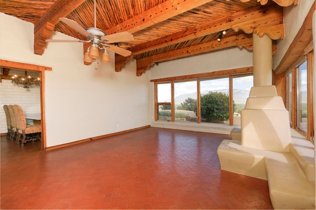 unfurnished living room featuring ceiling fan, beamed ceiling, and wooden ceiling