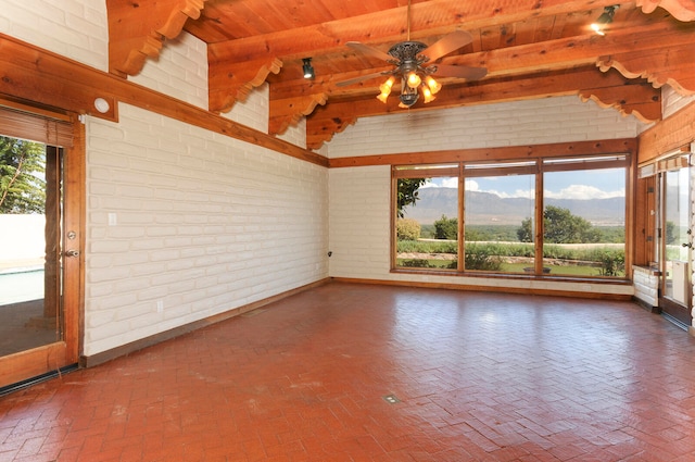 unfurnished sunroom with wooden ceiling, lofted ceiling with beams, ceiling fan, and a mountain view