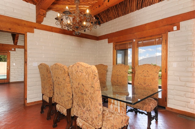 dining room with wood ceiling, beam ceiling, a chandelier, and brick wall