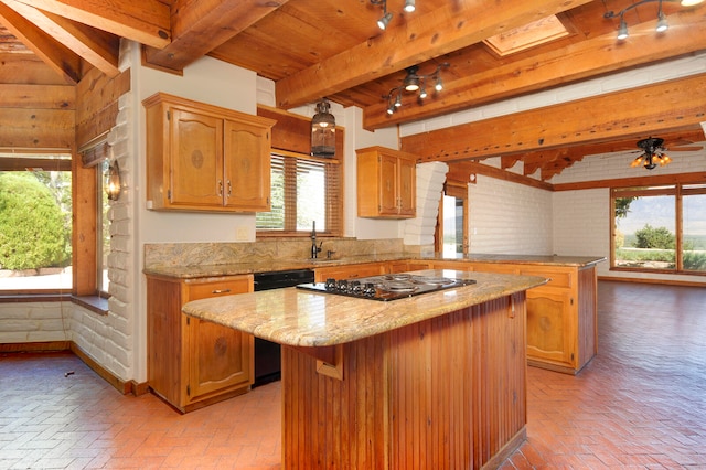 kitchen with plenty of natural light, a center island, and brick wall