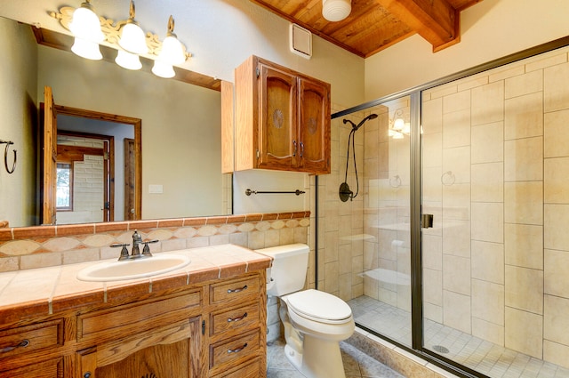 bathroom featuring vanity, tile patterned flooring, toilet, and a shower with door