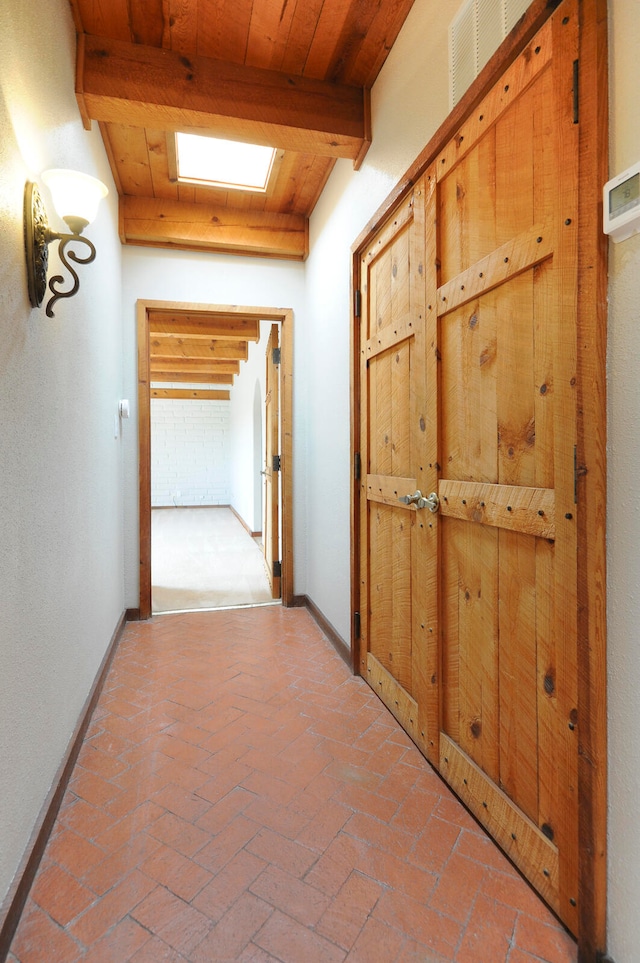 hallway featuring beamed ceiling and wooden ceiling