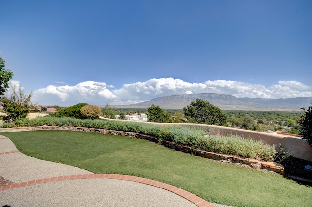 view of community featuring a lawn and a mountain view