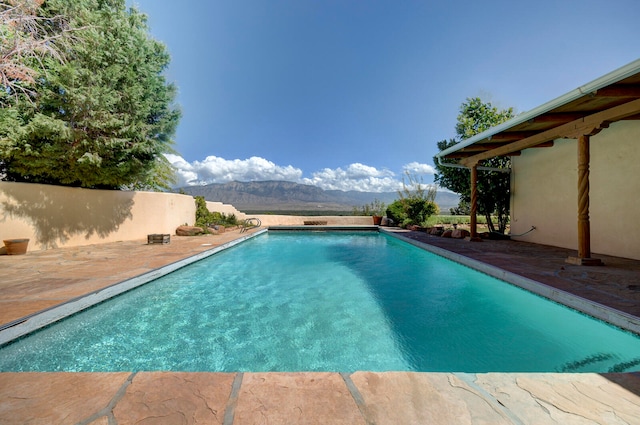 view of swimming pool with a mountain view