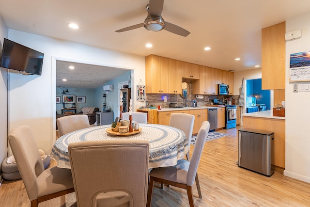 dining area with ceiling fan and light wood-type flooring