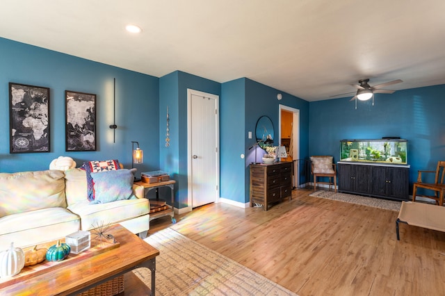 living room with ceiling fan and hardwood / wood-style floors