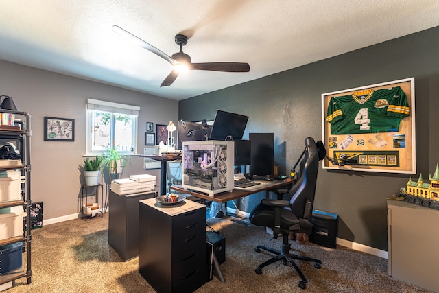 carpeted office featuring a textured ceiling and ceiling fan