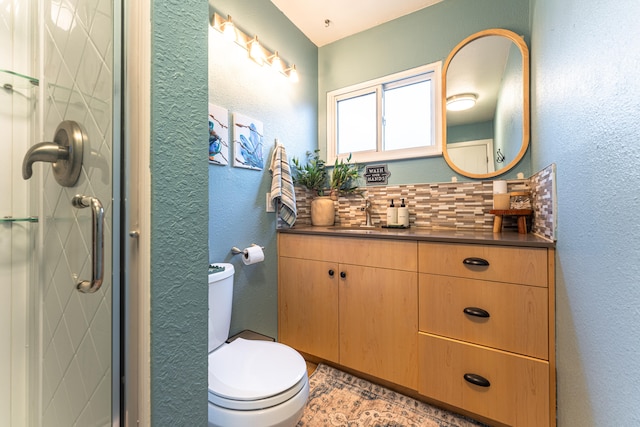 bathroom with decorative backsplash, walk in shower, vanity, and toilet