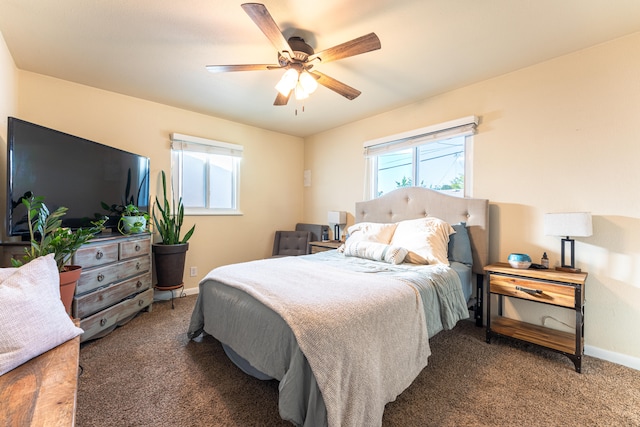 bedroom with dark colored carpet and ceiling fan