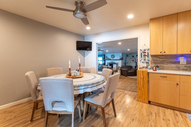 dining area featuring ceiling fan and light hardwood / wood-style flooring