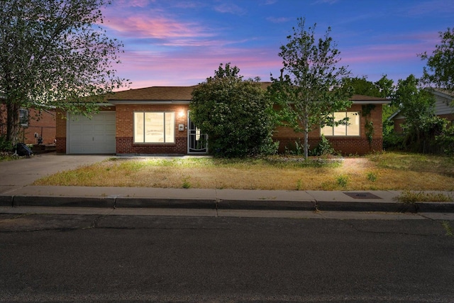 view of front facade with a garage and central AC