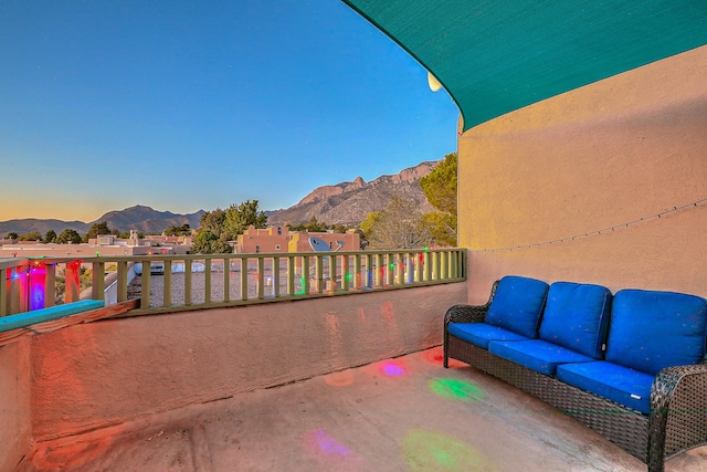 exterior space featuring a balcony and a mountain view