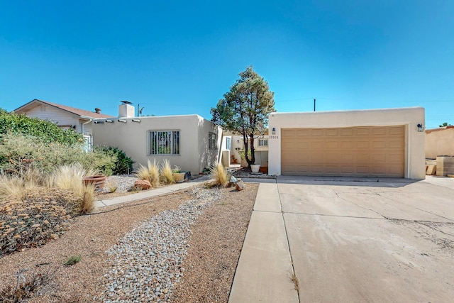 pueblo-style home with a garage