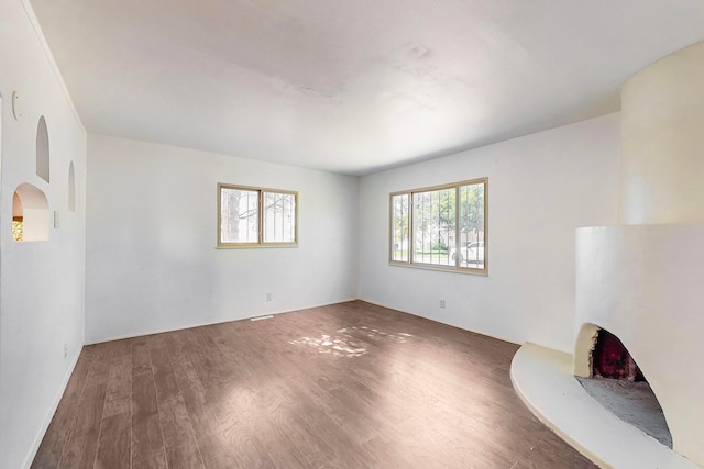 unfurnished living room with dark hardwood / wood-style flooring