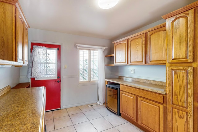 kitchen with wine cooler and light tile patterned flooring