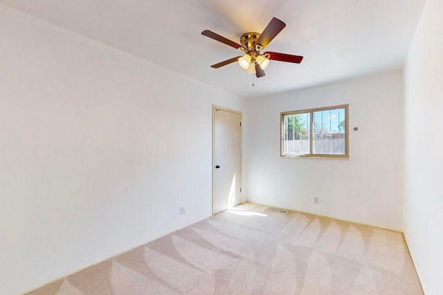 carpeted empty room with ceiling fan