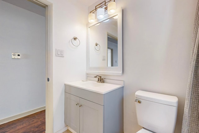 bathroom with vanity, hardwood / wood-style floors, and toilet