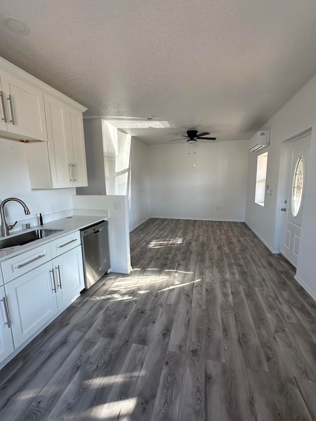 kitchen featuring white cabinetry, an AC wall unit, dishwasher, dark hardwood / wood-style flooring, and ceiling fan