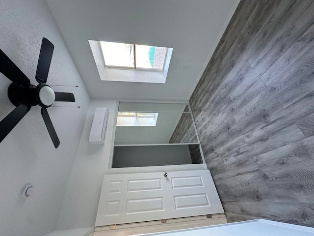 interior space featuring a skylight and ceiling fan