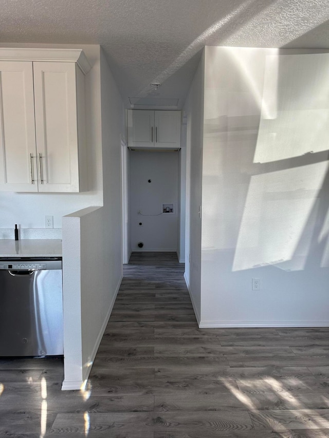 hallway featuring a textured ceiling and dark hardwood / wood-style floors