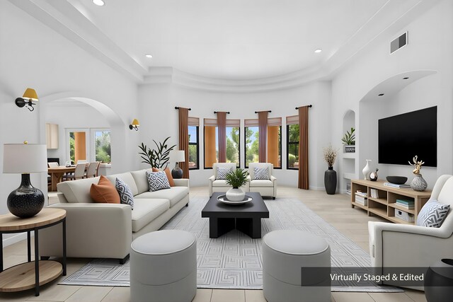 1220 Mesa Ridge Dr SW, Los Lunas, NM 87031 - living area with arched walkways, a towering ceiling, and recessed lighting