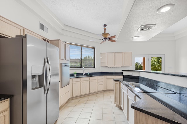 kitchen featuring a textured ceiling, ceiling fan, plenty of natural light, and stainless steel fridge