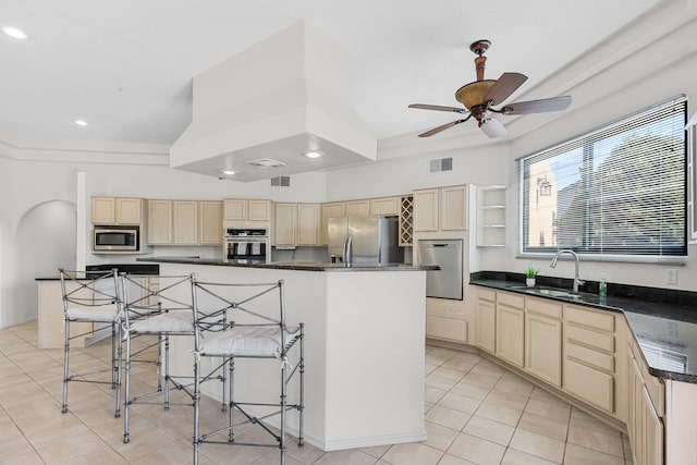 kitchen with a center island, sink, ceiling fan, and stainless steel appliances