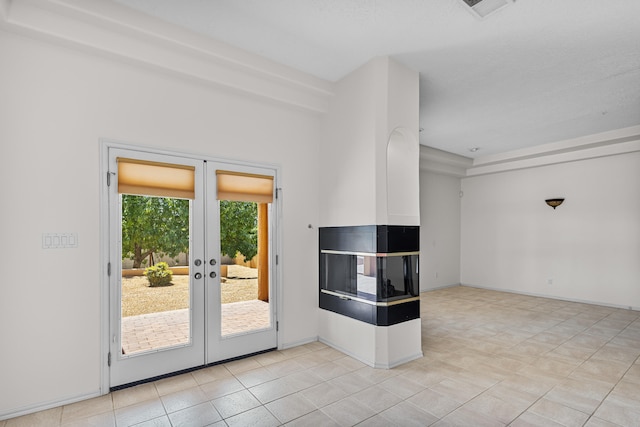 entryway featuring french doors and light tile patterned flooring