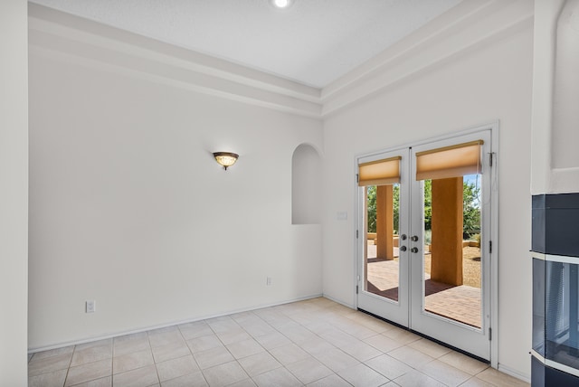 tiled empty room with french doors