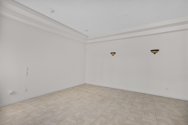 spare room with a textured ceiling